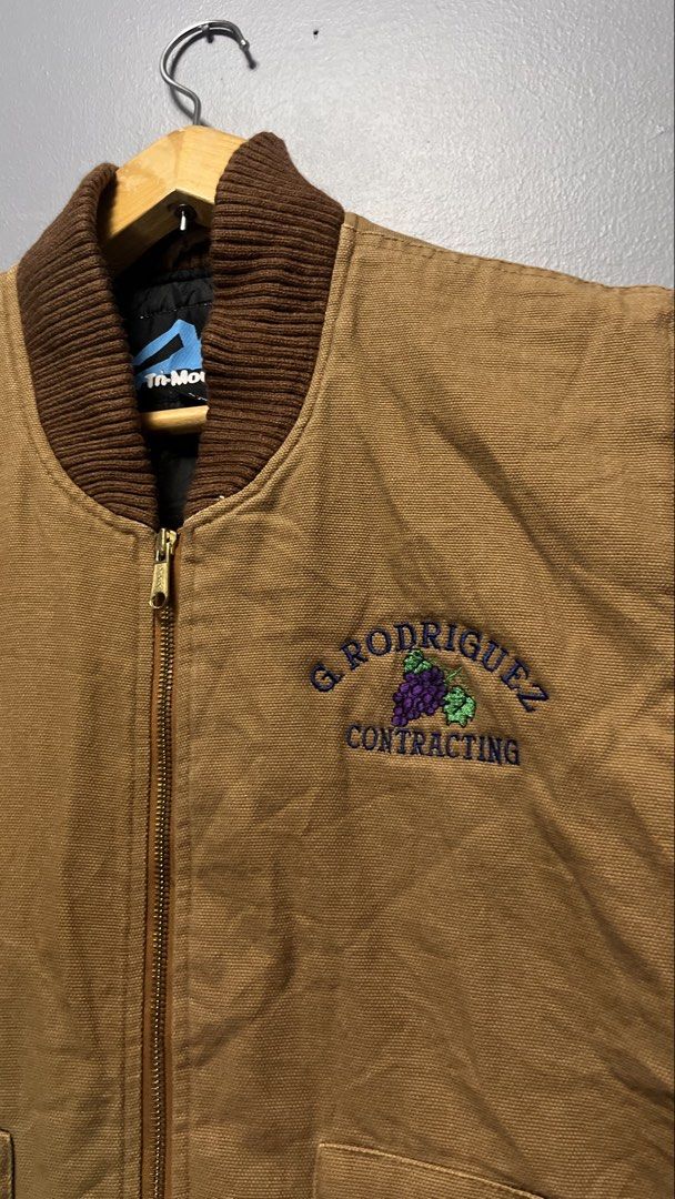 Tri-Mountain Contractor Work Vest (Category: Vests) located in Cabuyao City. Submitted by bulandos (Listing ID 1459333909, Image 2). Description: - Brand: Tri-Mountain - Type: Work Vest - Color: Brown Canvas - Size: Large (L) - Features: Quilted black lining for warmth, ribbed collar, two front pockets - Logo: Embroidered "G. Rodriguez Contracting" on chest - Origin: Made in Uzbekistan.