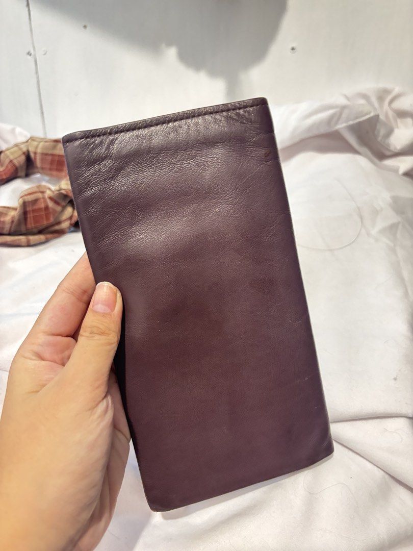 Tucano Leather Long Bifold Wallet (Category: Wallets & Card Holders) located in Lapu Lapu. Submitted by affordmo (Listing ID 1459332374, Image 3). Description: - Genuine maroon leather long wallet from Tucano. - Ample card slots for all your essentials. - Features a convenient mesh ID window. - Slim design, perfect for slipping into pockets or bags. - Excellent for keeping cash and cards organized. - Shows some signs of wear but remains in good, 