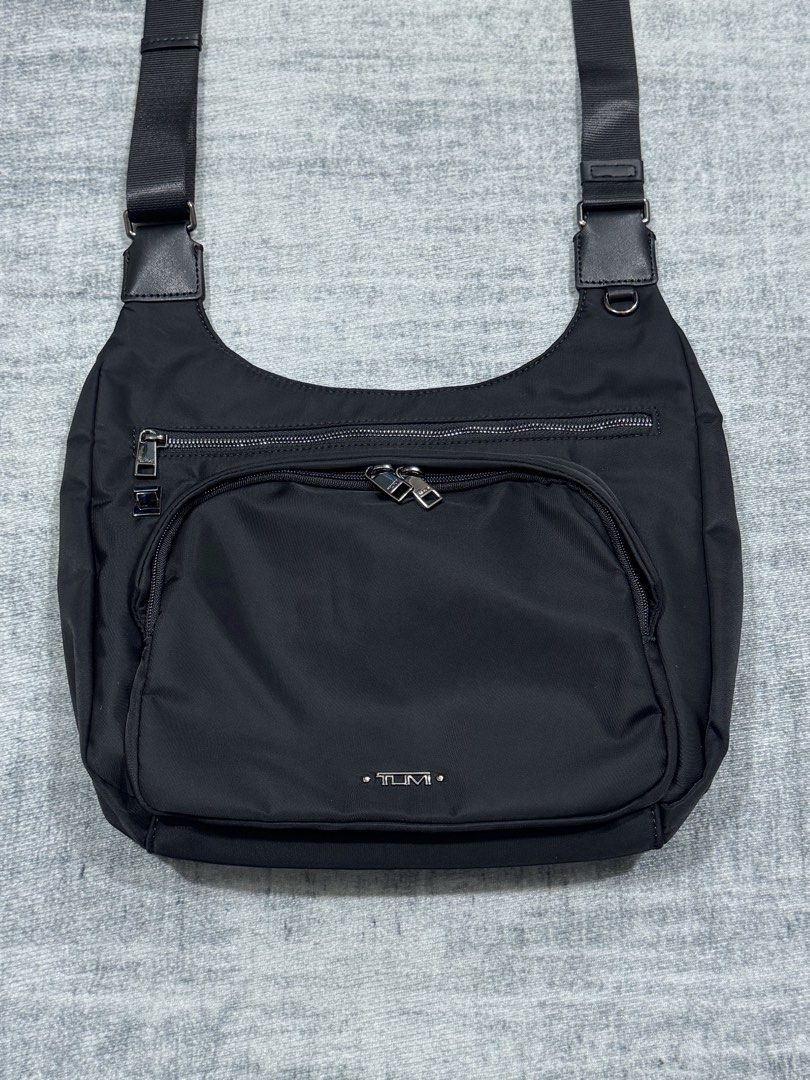 Tumi - Voyageur Sutton - Crossbody Shoulder Bag (Category: Sling Bags) located in Manila. Submitted by members-only (Listing ID 1459355382, Image 2). Description: Tumi Voyageur Sutton 12.75" Nylon Crossbody Shoulder Bag - Black with Silver Hardware Multiple compartments In great condition No major flaws Issue: Missing Tumi Accessory and Leather puller zipper. (check last 2 pics) No holes and scratches in nylon and leather Presentable .