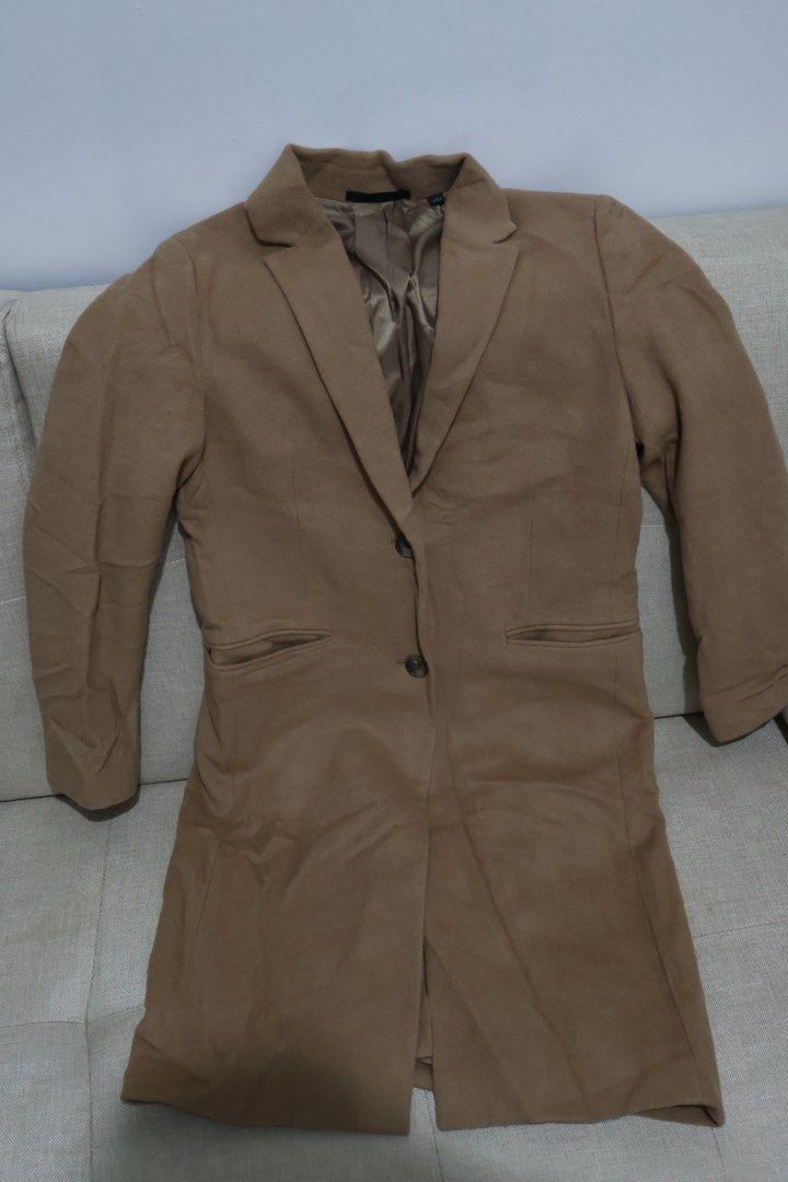 UNIQLO Wool Cashmere Blend Long Coat (Category: Coats, Jackets and Outerwear) located in Quezon City. Submitted by NiniTheExplorer (Listing ID 1459340924, Image 1). Description: - Classic camel long coat from UNIQLO - Made with a warm wool and cashmere blend - Features a single button closure - Two convenient front pockets - Fully lined for a smooth finish - Ideal for layering over any outfit - Perfect for staying cozy in cooler weather.