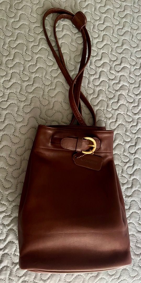Vintage Coach Cornelia Sling/Backpack (Category: Luxury Bags & Wallets) located in Taguig. Submitted by chu2600 (Listing ID 1459310069, Image 1). Description: - Authenticated Classic brown leather Coach bucket bag with brass hardware - Drawstring closure with front buckle - Interior zip pocket for essentials - Made in 1997 in the USA - Serial number: B7H-4162 - Perfect everyday bag.