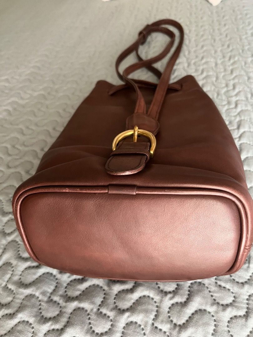 Vintage Coach Cornelia Sling/Backpack (Category: Luxury Bags & Wallets) located in Taguig. Submitted by chu2600 (Listing ID 1459310069, Image 3). Description: - Authenticated Classic brown leather Coach bucket bag with brass hardware - Drawstring closure with front buckle - Interior zip pocket for essentials - Made in 1997 in the USA - Serial number: B7H-4162 - Perfect everyday bag.
