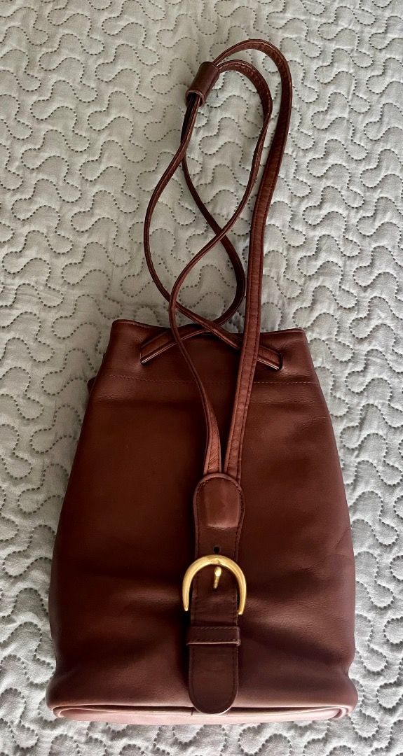 Vintage Coach Cornelia Sling/Backpack (Category: Luxury Bags & Wallets) located in Taguig. Submitted by chu2600 (Listing ID 1459310069, Image 2). Description: - Authenticated Classic brown leather Coach bucket bag with brass hardware - Drawstring closure with front buckle - Interior zip pocket for essentials - Made in 1997 in the USA - Serial number: B7H-4162 - Perfect everyday bag.