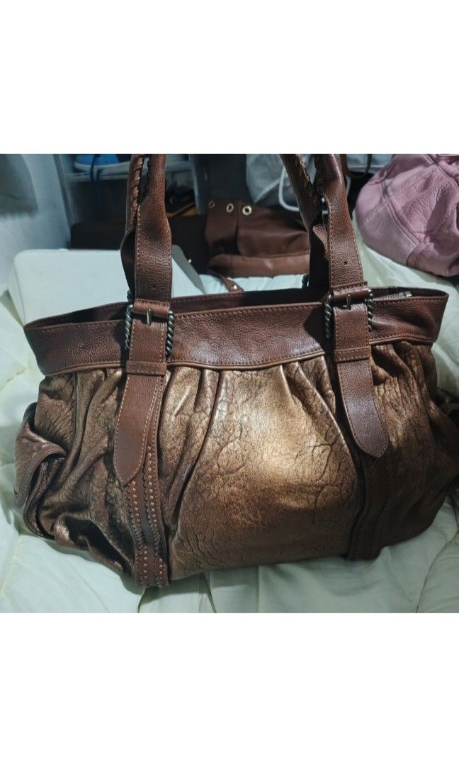 Vintage Cole Haan Metallic Brown (Category: Luxury Bags & Wallets) located in Urdaneta. Submitted by bernalyn25 (Listing ID 1459428747, Image 2). Description: -Metallic brown leather bag - Braided handles - Zip closure - Spacious interior - Unique textured leather look - Perfect for everyday.