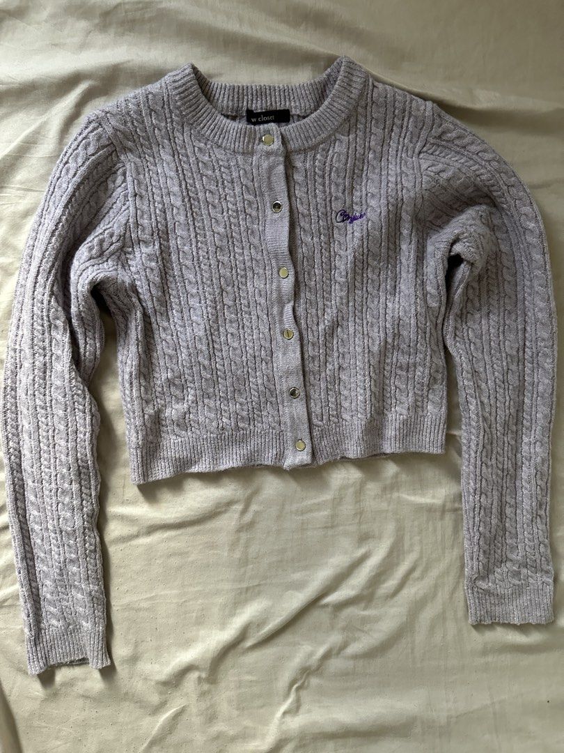 W Closet Cable Knit Cropped Cardigan (Category: Coats, Jackets and Outerwear) located in Lipa City. Submitted by chiechums (Listing ID 1459341559, Image 1). Description: - Brand: W Closet - Color: Light Purple - Style: Cropped Cable Knit Cardigan - Features: Button front closure, small embroidered detail on chest - Styling: Pairs well with high-waisted jeans or skirts - Occasion: Comfortable and stylish for everyday wear.