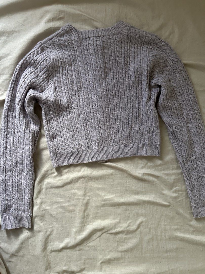 W Closet Cable Knit Cropped Cardigan (Category: Coats, Jackets and Outerwear) located in Lipa City. Submitted by chiechums (Listing ID 1459341559, Image 3). Description: - Brand: W Closet - Color: Light Purple - Style: Cropped Cable Knit Cardigan - Features: Button front closure, small embroidered detail on chest - Styling: Pairs well with high-waisted jeans or skirts - Occasion: Comfortable and stylish for everyday wear.