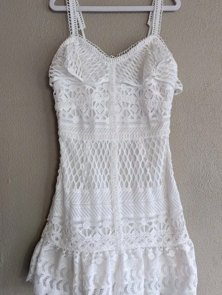 White Eyelet Lace ruffle mini dress (Category: Dresses) located in Pasig City. Submitted by aiyee18 (Listing ID 1459346456, Image 3). Description: White Eyelet Lace Ruffle Mini Dress * Brand: J.O.A. * Color: White * Style: Feminine & romantic * Intricate all-over lace detailing * Adjustable spaghetti straps * Sweetheart-style bust with delicate ruffle/lace accents * Fitted bodice with a slightly flared A-line mini skirt * Scalloped lace hem * Bea