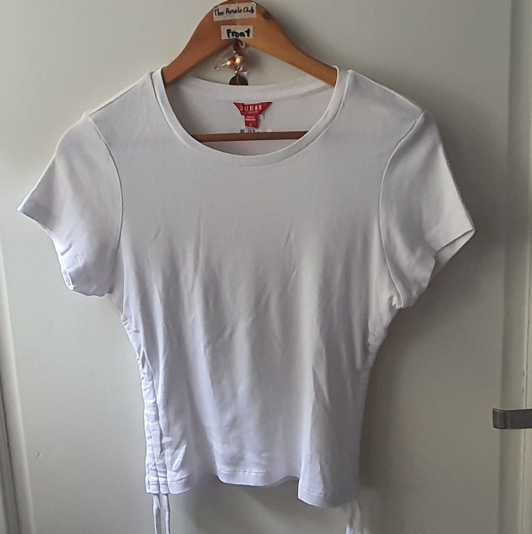 White Guess Ribbed Cropped T-shirt with Side Drawstrings (Category: Shirts) located in Tarlac. Submitted by resaleclub (Listing ID 1459391392, Image 1). Description: - White Guess ribbed t-shirt - Cropped fit - Adjustable drawstrings on sides - Size: L - Measurements: 15" wide, 20" long - Made in Bangladesh - Perfect basic piece for any outfit.