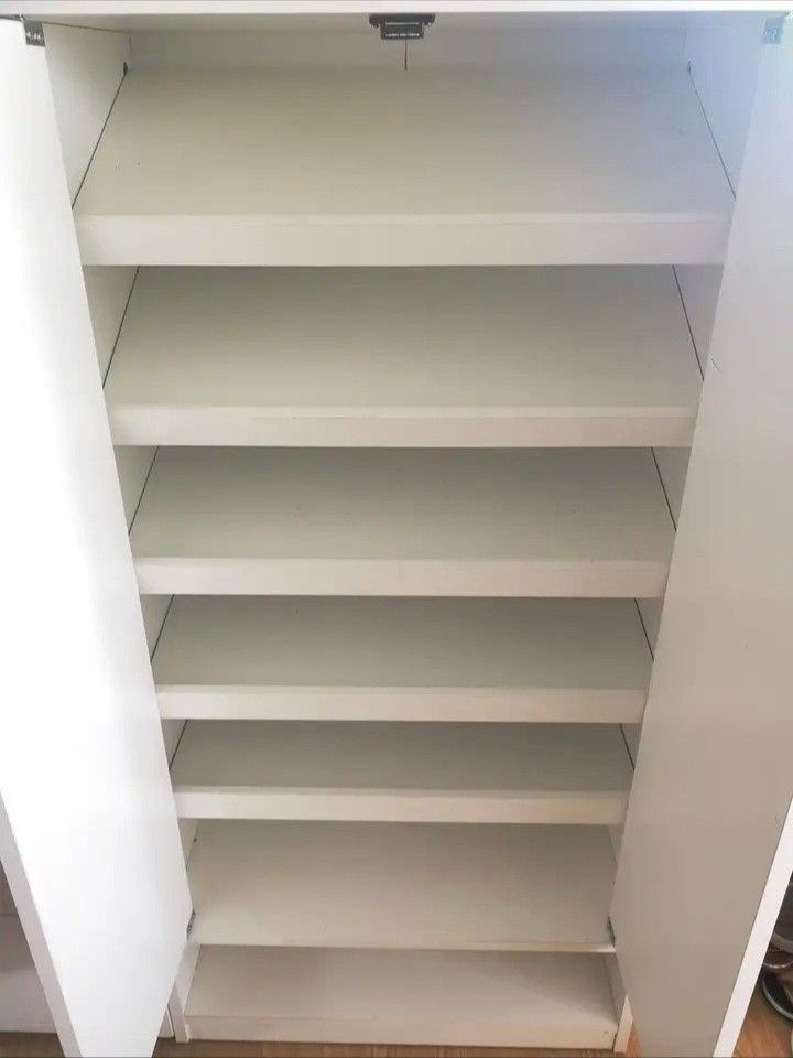 White Two-Door Cabinet with Shelves (Pezzo) (Category: Shelves, Cabinets & Racks) located in Paranaque City. Submitted by nicessities (Listing ID 1459291176, Image 2). Description: **Pezzo Shoe Cabinet, White - Php 3,000.00 (used as shoe cabinet but with matting) *Lightly used *RFS: Migrating - Two doors with multiple interior shelves for organized storage - Open shelf space at the bottom - Simple, versatile design suitable for any room - Can be 