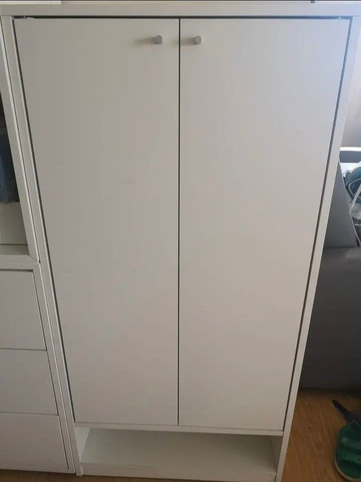White Two-Door Cabinet with Shelves (Pezzo) (Category: Shelves, Cabinets & Racks) located in Paranaque City. Submitted by nicessities (Listing ID 1459291176, Image 1). Description: **Pezzo Shoe Cabinet, White - Php 3,000.00 (used as shoe cabinet but with matting) *Lightly used *RFS: Migrating - Two doors with multiple interior shelves for organized storage - Open shelf space at the bottom - Simple, versatile design suitable for any room - Can be 