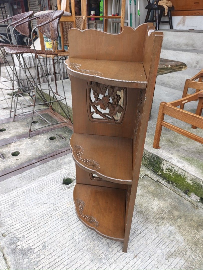 Wooden Corner Shelf with Carved Grape Design (Category: Shelves, Cabinets & Racks) located in Valenzuela. Submitted by kendra071914 (Listing ID 1459361843, Image 2). Description: - Three-tiered wooden corner shelf - Features intricate carved grape vine details on side panels - Perfect for plants, books, or decor - Space-saving design for any corner - Warm, brown wood finish - Shows minor scuffs from normal use.