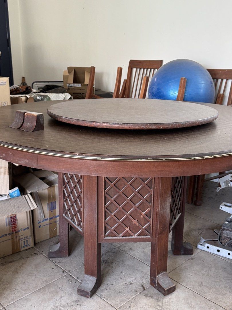 Wooden Round Dining Table with Lazy Susan (Category: Tables & Sets) located in Manila. Submitted by .famousamos (Listing ID 1459342573, Image 1). Description: - antique round wooden dining table - Includes a rotating lazy susan top - Decorative lattice design on the base - Ideal for family gatherings - Note: Some wear on the edges - Selling as is - 54 inches diameter. 29.5inch height - dining chairs not included .