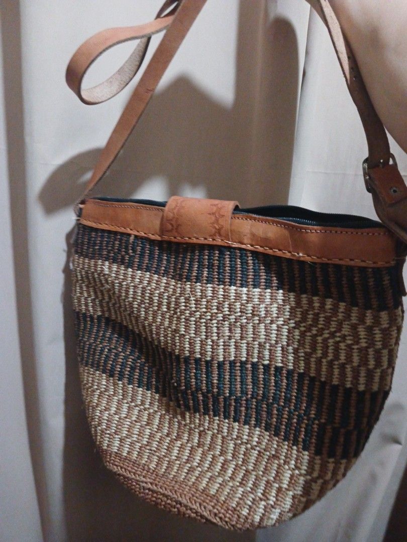 Woven Crossbody Bag with Leather Strap (Category: Cross-body Bags) located in Manila. Submitted by acezenergy (Listing ID 1459407920, Image 3). Description: - Cute woven bag with a stylish striped pattern. - Features tan leather strap and details. - Adjustable strap with a buckle for a customized fit. - Secure closure with a leather tab. - Ideal for everyday use. - Unique and eye-catching design. selling this unused bag for only 2k, very stylish 
