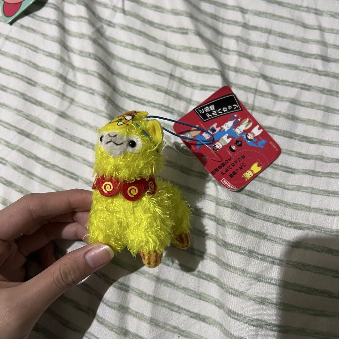 yellow Amuse Alpacasso alpaca plush keychain (Category: Plushies & Soft Toys) located in Manila. Submitted by erickalago (Listing ID 1459454111, Image 1). Description: no issue loc: manila & makati.