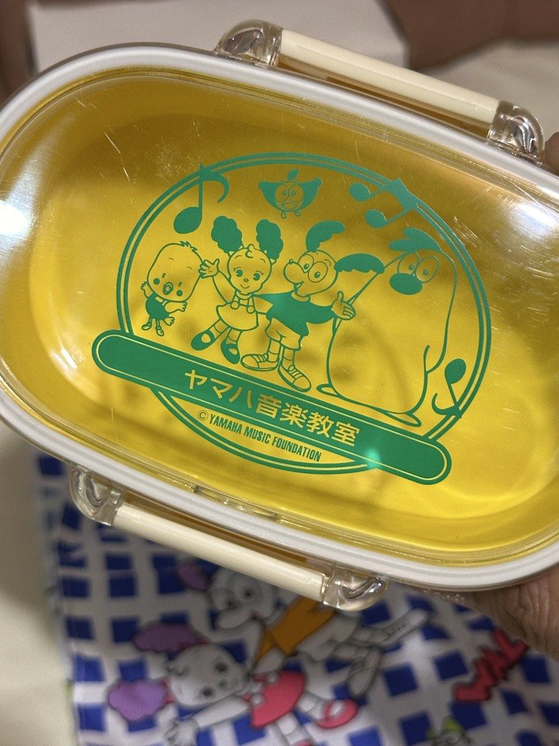 yellow double-layer plastic lunch box with fabric table napkin (Category: Food Organization & Storage) located in Davao. Submitted by favoritepreloved (Listing ID 1459395779, Image 3). Description: 💜 13cm x 7.5cm 💜 with a clear lid and a matching blue-and-white patterned utility cloth 💜 made in Japan.