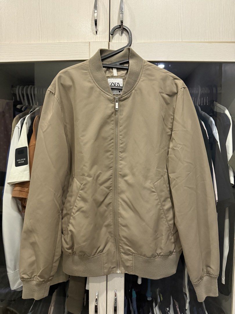 Zara Beige Bomber Jacket (Category: Coats, Jackets and Outerwear) located in Cebu City. Submitted by takeitfrom.me (Listing ID 1459316587, Image 2). Description: - Classic beige bomber jacket from Zara - Zip-up front - Two side pockets - Ribbed collar, cuffs, and hem - Versatile for layering or standalone wear - Neutral color complements any wardrobe.