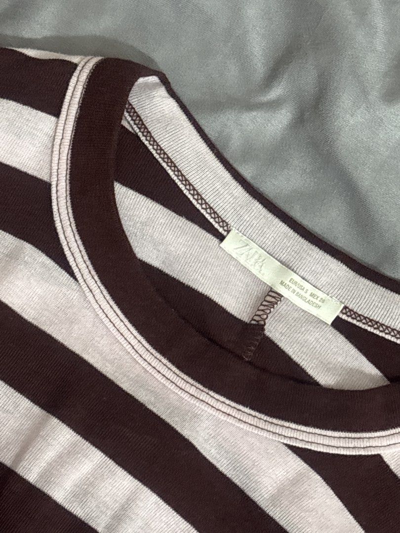 ZARA Striped Long Sleeve Crop Top (Category: Longsleeves) located in Manila. Submitted by de.clutterthings (Listing ID 1459323739, Image 3). Description: - Zara striped crop top - Colors: Brown and soft pinkish-white stripes - Style: Long sleeves, fitted - Length: Hits right above the belly button - Versatile: Pairs well with high-waisted jeans or skirts - Perfect for: Comfortable and stylish everyday wear - Negotiable!.