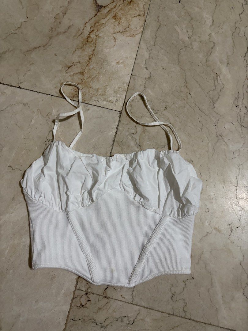 Zara White Ruched Corset Crop Top (Category: Sleeveless) located in Bacoor. Submitted by gailscollections (Listing ID 1459487113, Image 2). Description: Chic Zara white crop top featuring a gathered ruched neckline, delicate spaghetti straps, and a fitted corset-style silhouette. The ribbed stretch fabric and seam detailing create a flattering, feminine shape. Perfect for pairing with jeans, skirts, or tailored trousers for an effortless everyday