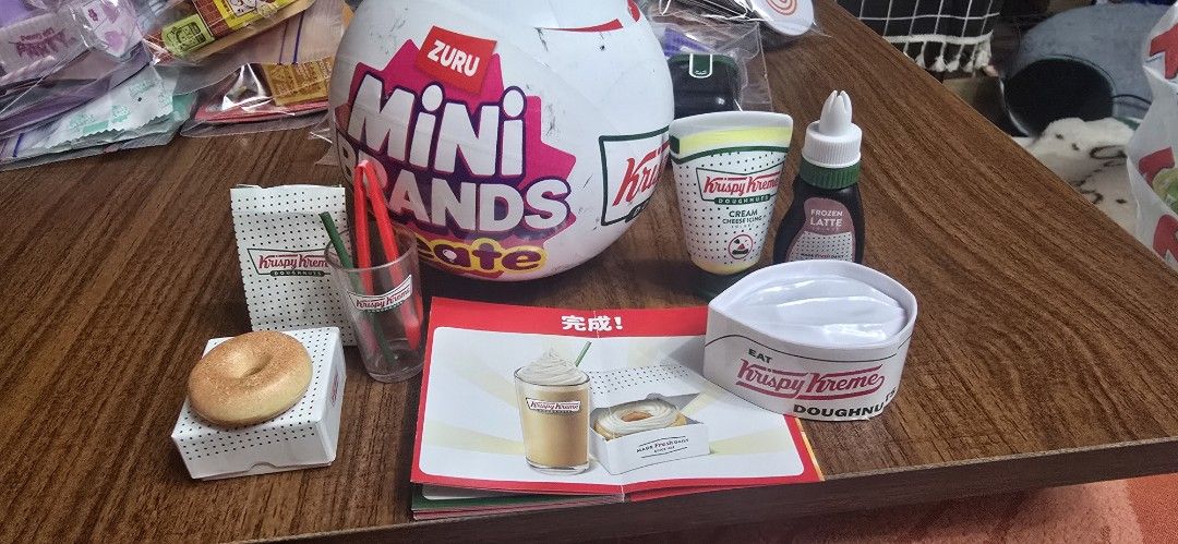 Zuru Mini Brands Krispy Kreme Playset with Accessories (Category: Kids Toys) located in Taguig. Submitted by jaymars16 (Listing ID 1459395728, Image 3). Description: - Authentic Mini Brands Krispy Kreme collection. - Includes a mini donut and a mini drink cup. - Opened to check if duplicate - Comes with additional accessories. - Features a mini Krispy Kreme hat. - Includes a small display box for showcasing. - Ideal for collectors and imaginative