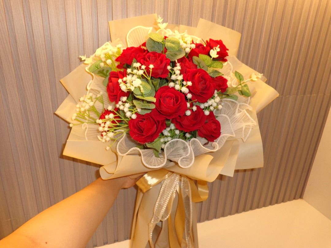18 Red artificial rose flower bouquet with wrapping (Category: Flowers & Bouquets) located in Caloocan City. Submitted by gentletree_11a141 (Listing ID 1465065938, Image 1). Description: - Artificial red rose bouquet that will never wither - Accented with fresh-looking baby's breath and eucalyptus leaves - Wrapped in stylish beige paper with a white mesh ruffle trim - Finished with a shiny gold ribbon tie - Ideal gift for birthdays, anniversaries