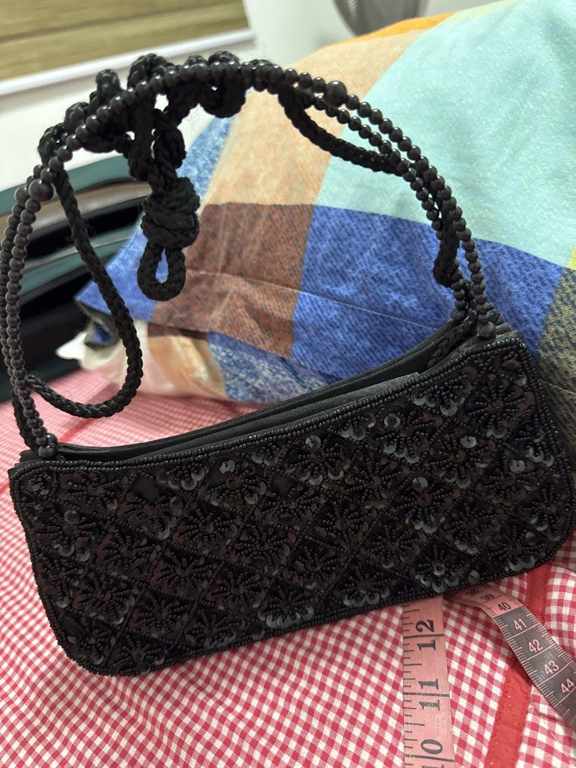 2027 Black Beaded Sequin Evening Bag Shoulder Bag (Category: Shoulder Bags) located in Silang. Submitted by sari2bilina (Listing ID 1465126459, Image 1). Description: - Color: Classic black - Design: Full front sequin and beadwork with smooth black back and bottom - Dimensions: Approx. 11 inches long x 5 inches tall - Features: Elegant beaded handle and secure zipper top closure - Perfect for: Nights out, parties, and special occasions - Conditio