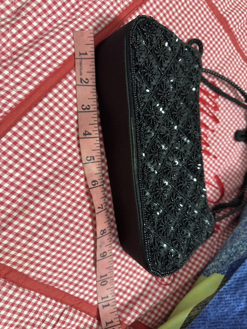 2027 Black Beaded Sequin Evening Bag Shoulder Bag (Category: Shoulder Bags) located in Silang. Submitted by sari2bilina (Listing ID 1465126459, Image 2). Description: - Color: Classic black - Design: Full front sequin and beadwork with smooth black back and bottom - Dimensions: Approx. 11 inches long x 5 inches tall - Features: Elegant beaded handle and secure zipper top closure - Perfect for: Nights out, parties, and special occasions - Conditio