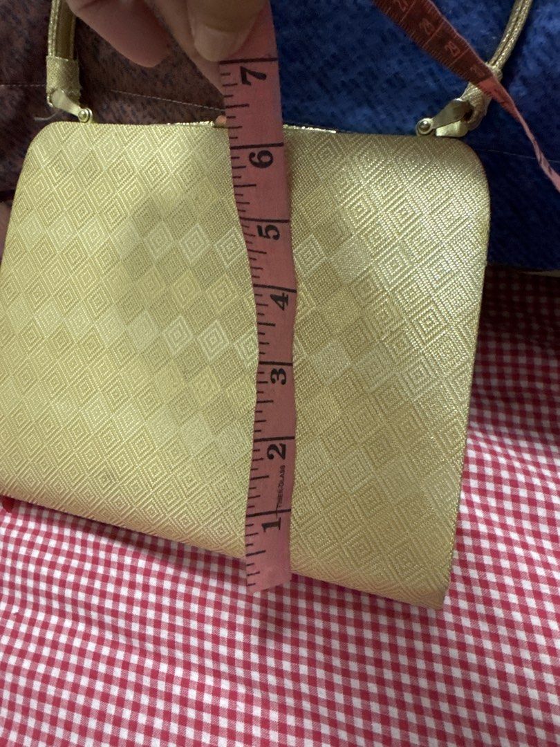 2027 Gold patterned evening handbag clutch with strap (Category: Clutches) located in Silang. Submitted by sari2bilina (Listing ID 1465124897, Image 2). Description: - Stunning gold handbag with a chic geometric diamond pattern - Eye-catching metallic fabric finish all over - Secure metal top clasp closure - Single matching shoulder strap with gold-tone hardware - Compact size: approx. 6-7 inches wide and 5 inches tall - EUC, perfect for events a