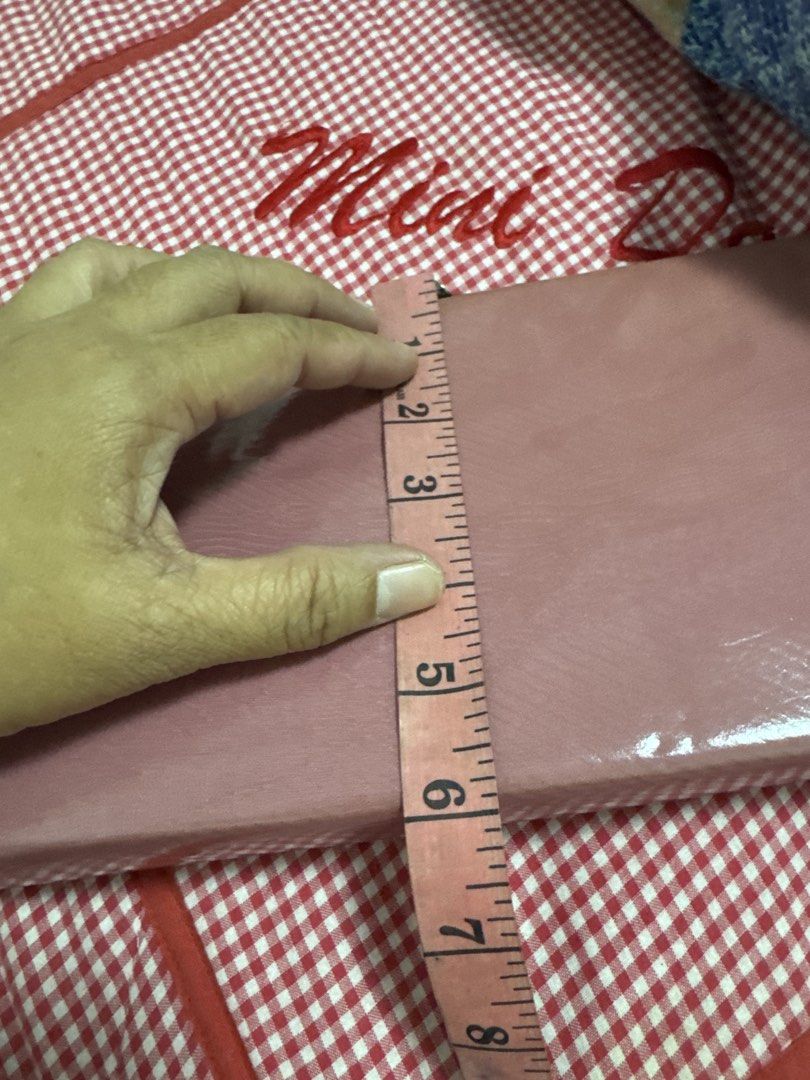 2027 Pink rectangular evening clutch bag with metal clasp (Category: Clutches) located in Silang. Submitted by sari2bilina (Listing ID 1465125336, Image 2). Description: - Color: Solid pink with a shiny finish - Hardware: Silver-tone with a secure snap closure clasp - Details: Beautiful floral etching on the interior metal trim - Size: Approximately 8 inches wide - Condition: Clean surface all around, locks securely.