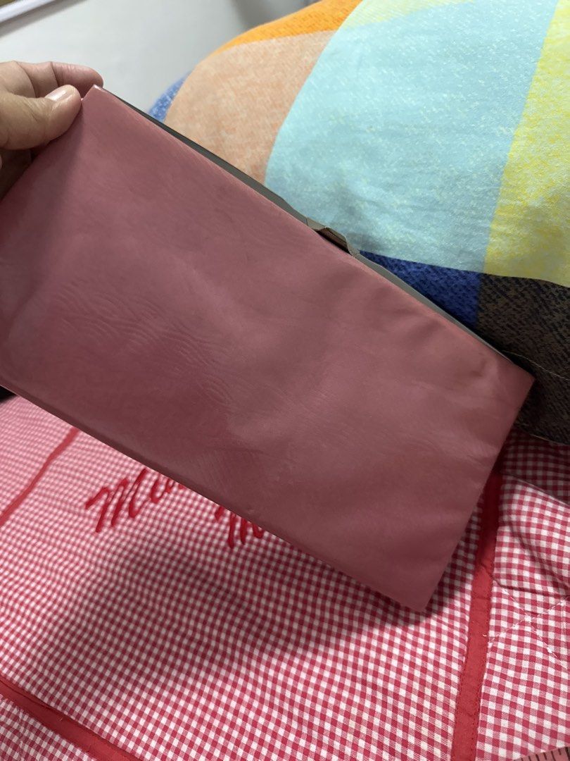 2027 Pink rectangular evening clutch bag with metal clasp (Category: Clutches) located in Silang. Submitted by sari2bilina (Listing ID 1465125336, Image 1). Description: - Color: Solid pink with a shiny finish - Hardware: Silver-tone with a secure snap closure clasp - Details: Beautiful floral etching on the interior metal trim - Size: Approximately 8 inches wide - Condition: Clean surface all around, locks securely.