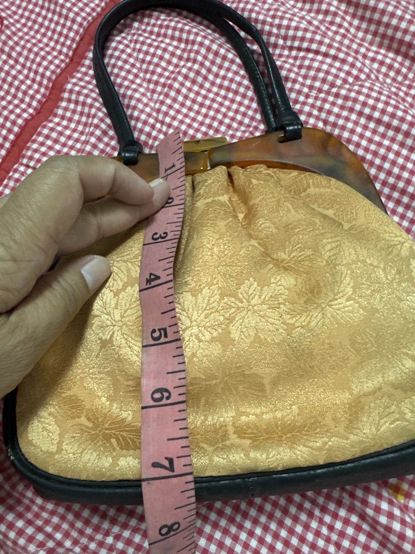 2027 Vintage yellow Gold Leaf Pattern Handbag Tortoise Shell Frame (Category: Luxury Bags & Wallets) located in Silang. Submitted by sari2bilina (Listing ID 1465121598, Image 3). Description: - Vintage-style gold fabric handbag with a gorgeous leaf floral pattern - Dark brown faux leather trim and sturdy twin top handles - Unique tortoise shell pattern plastic frame with a secure top clasp closure - Compact size: roughly 8 inches wide and 2 inche