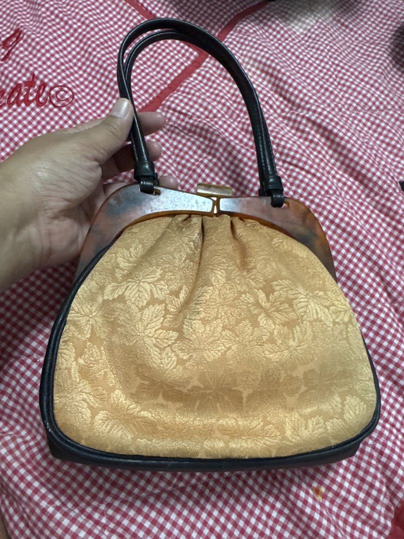 2027 Vintage yellow Gold Leaf Pattern Handbag Tortoise Shell Frame (Category: Luxury Bags & Wallets) located in Silang. Submitted by sari2bilina (Listing ID 1465121598, Image 1). Description: - Vintage-style gold fabric handbag with a gorgeous leaf floral pattern - Dark brown faux leather trim and sturdy twin top handles - Unique tortoise shell pattern plastic frame with a secure top clasp closure - Compact size: roughly 8 inches wide and 2 inche