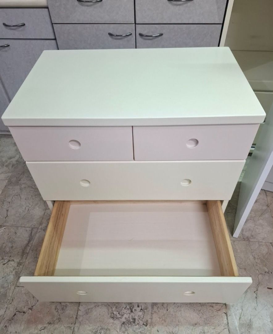 4-Drawer Storage Chest Dresser Unit (Category: Shelves, Cabinets & Racks) located in Quezon City. Submitted by japandemanila (Listing ID 1465007399, Image 2). Description: - 4-drawer storage unit: 2 smaller top drawers and 2 larger bottom drawers - Elegant smooth cream finish with pale pink accent panels - Modern circular recessed pull handles - Dimensions: 31.5"W x 19.7"D x 28.4"H - Clean interior wooden drawer construction.