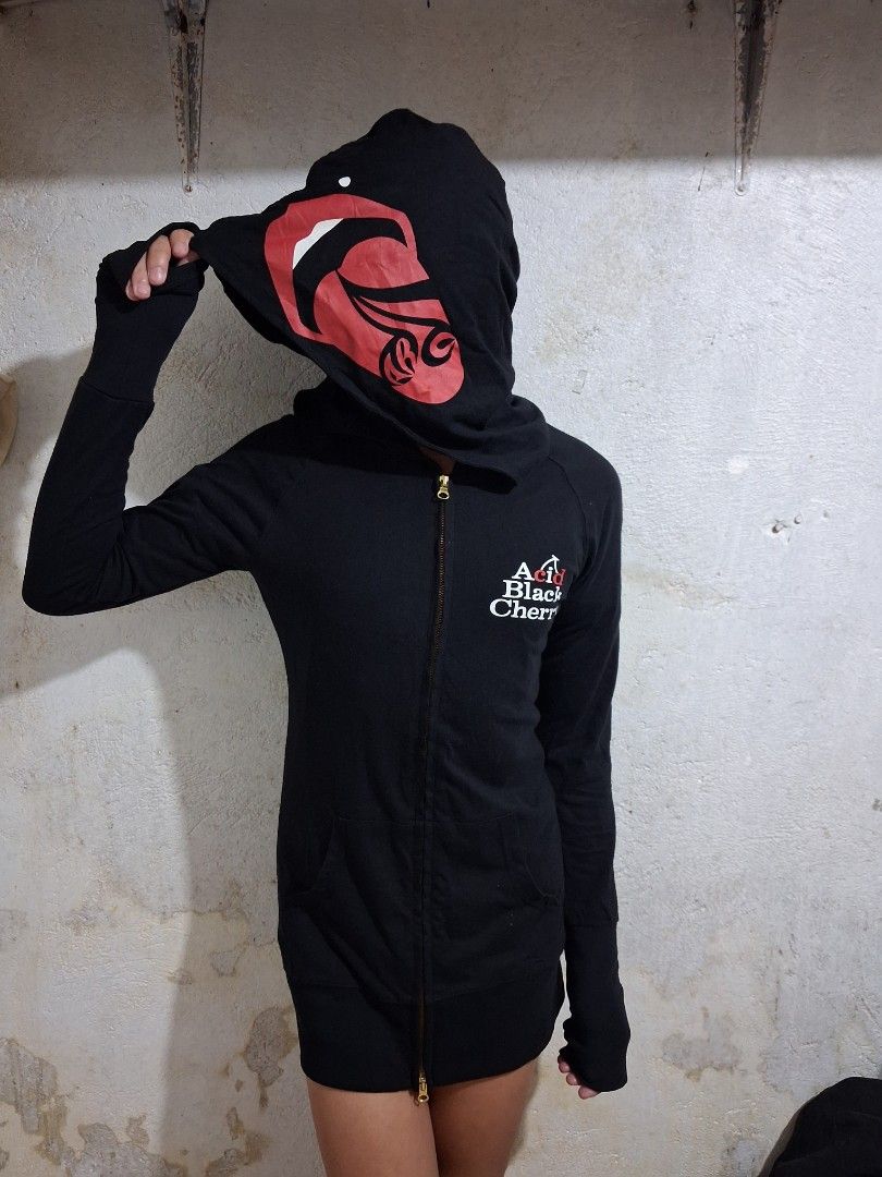Acid Black Cherry Zip-Up Hoodie (Category: Coats, Jackets and Outerwear) located in Manila. Submitted by rossthrift (Listing ID 1465130785, Image 2). Description: Black zip-up hoodie from Acid Black Cherry. Big red and white graphic prints on the back and hood. Text reads 'SUCK YOU' near the lower back hem. Small brand logo printed on the chest. Long sleeves with thumb holes. Full zipper closure down the front..