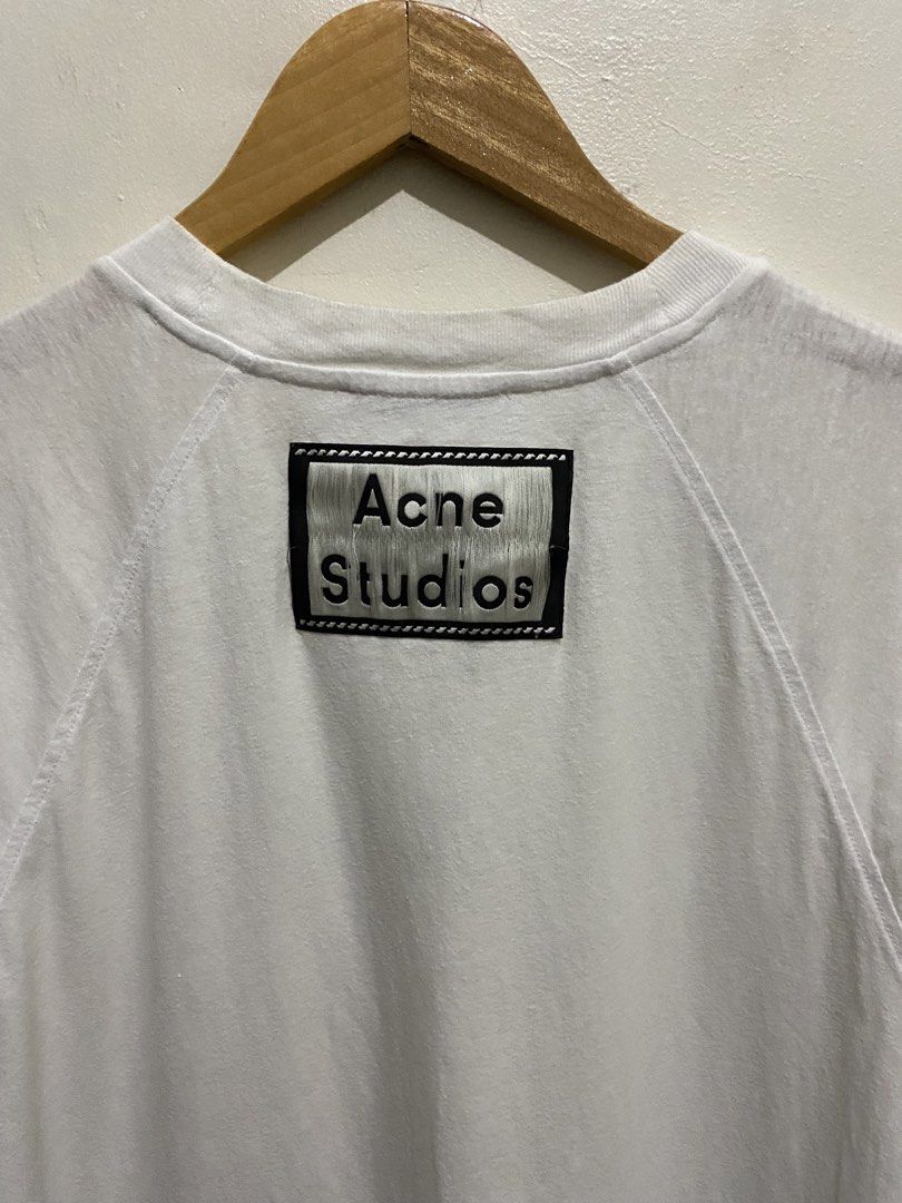 Acne Studios White Pocket T-Shirt Size M (Category: Shirts) located in Cainta. Submitted by mars_olavere (Listing ID 1465099189, Image 3). Description: - Brand: Acne Studios - Color: White - Size: M (180/96A) - Material: 100% Cotton, Made in Portugal - Fit: Classic everyday fit - Details: Raglan sleeves, front chest pocket, signature branding patch on back collar - Condition: Excellent, must-have Stockholm staple.