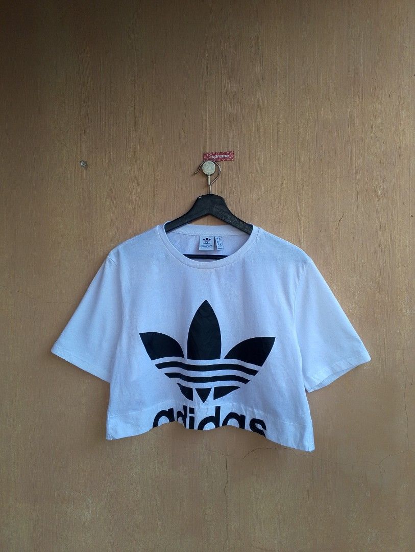 Adidas Big Logo Cut Out Cropped Tee (Category: Shirts) located in Lipa City. Submitted by MEECHYTWO2TWO (Listing ID 1465005790, Image 1). Description: • ADIDAS BIG LOGO CUT OUT TEE - Size: UK:6 / US: XS / JP: M - Best fit S-M - Width: 19 / Length: 16.5 - No issue - Location: Lipa City, Batangas - Excellent condition - Color rate: 10/10 - Additional sf +75 - Mop: GCASH/NO COD - Payment first tomorrow will be shipped.