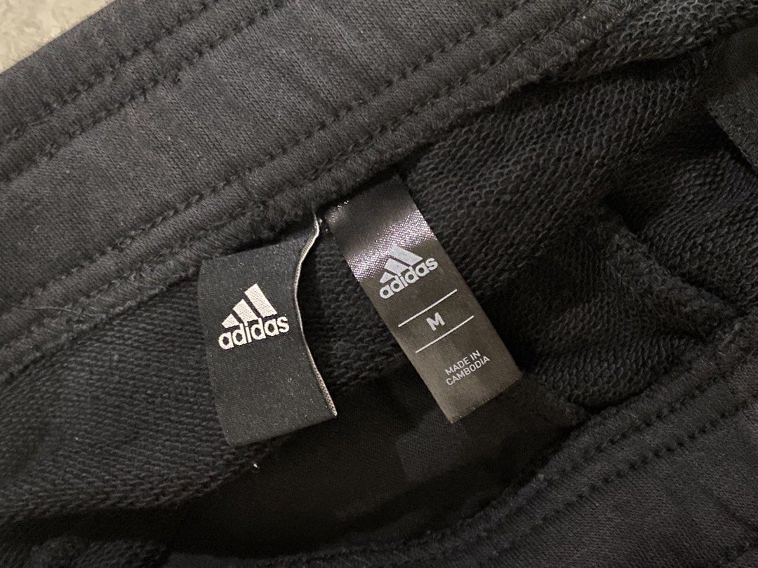 Adidas Black 3-Stripe Capri Joggers Size M (Category: Joggers) located in Taguig. Submitted by _lly.wyn (Listing ID 1464989912, Image 2). Description: - Brand: Adidas - Style: Black capri joggers with white 3-stripes - Size: Medium - Origin: Made in Cambodia - Material: Comfortable cotton blend - Features: Elastic waistband with adjustable drawstring, ribbed hem cuffs - Condition: 100% Authentic, great for workouts or casual wear.