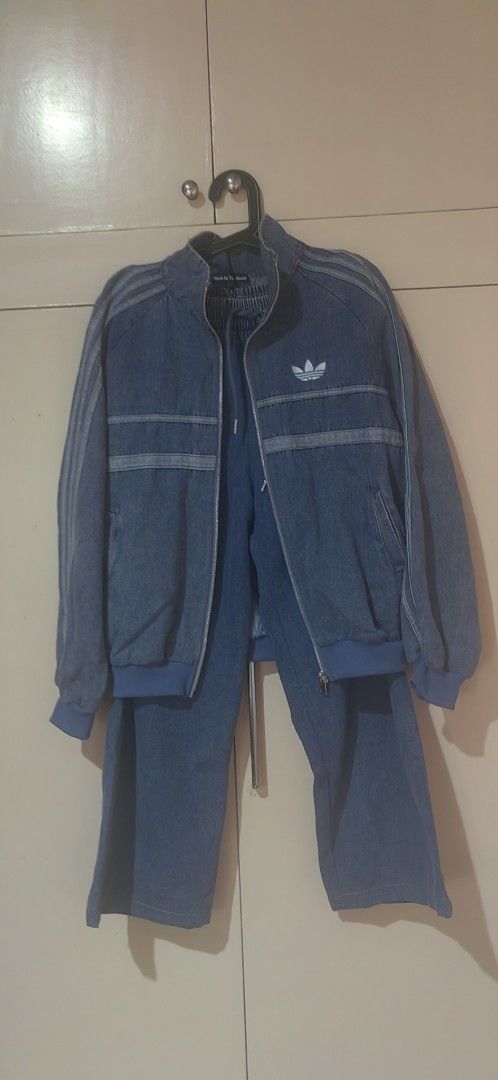 Adidas Denim Tracksuit Jacket And Pants Set (Category: Coats, Jackets and Outerwear) located in Basista. Submitted by hupomeno (Listing ID 1464969056, Image 2). Description: - Matching denim tracksuit set including a zip-up jacket and wide-leg pants - Classic blue denim wash with white Adidas trefoil logo and iconic sleeve stripes - Pants equipped with a comfortable elastic waistband and adjustable drawstrings - Features an authentic Made in Thai