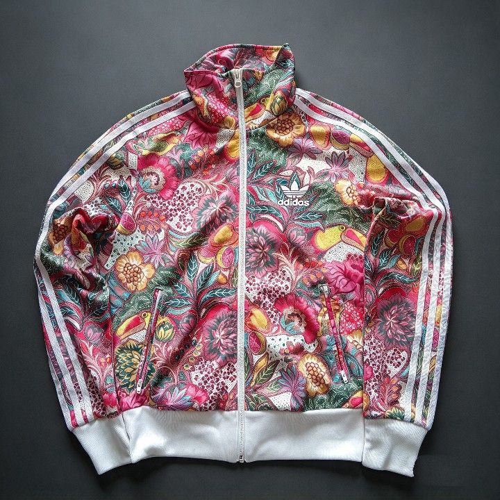 Adidas Floral Track Jacket Multi-color (Category: Coats, Jackets and Outerwear) located in Baguio. Submitted by miishaysh67446 (Listing ID 1465018663, Image 2). Description: - Brand: Adidas - Style: Track jacket with full zip and stand-up collar - Design: Vibrant tropical floral and bird print with classic white three-stripes - Details: Ribbed white cuffs and hem, large white Trefoil logo on the back - Material: 100% polyester - Condition: Excell