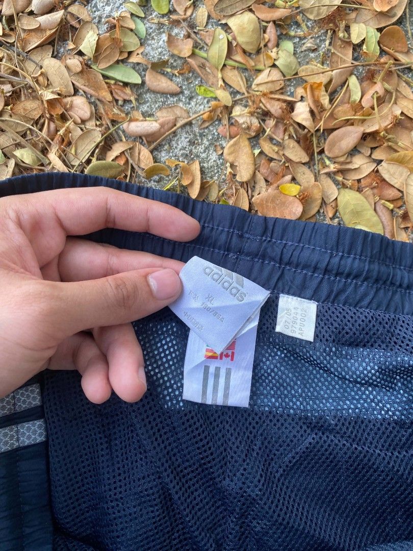 Adidas Navy Blue Track Pants Size XL (Category: Joggers) located in Manila. Submitted by bognalosjo69319 (Listing ID 1465134049, Image 3). Description: - Brand: Adidas - Color: Navy blue with light blue side panels - Size: Men's XL - Fit: Classic retro athletic fit - Features: Elastic waistband, mesh inner lining, and small printed logo near the left pocket.