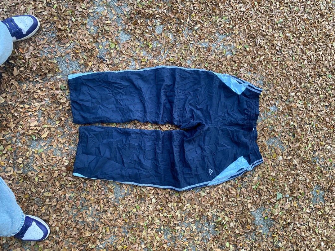 Adidas Navy Blue Track Pants Size XL (Category: Joggers) located in Manila. Submitted by bognalosjo69319 (Listing ID 1465134049, Image 1). Description: - Brand: Adidas - Color: Navy blue with light blue side panels - Size: Men's XL - Fit: Classic retro athletic fit - Features: Elastic waistband, mesh inner lining, and small printed logo near the left pocket.