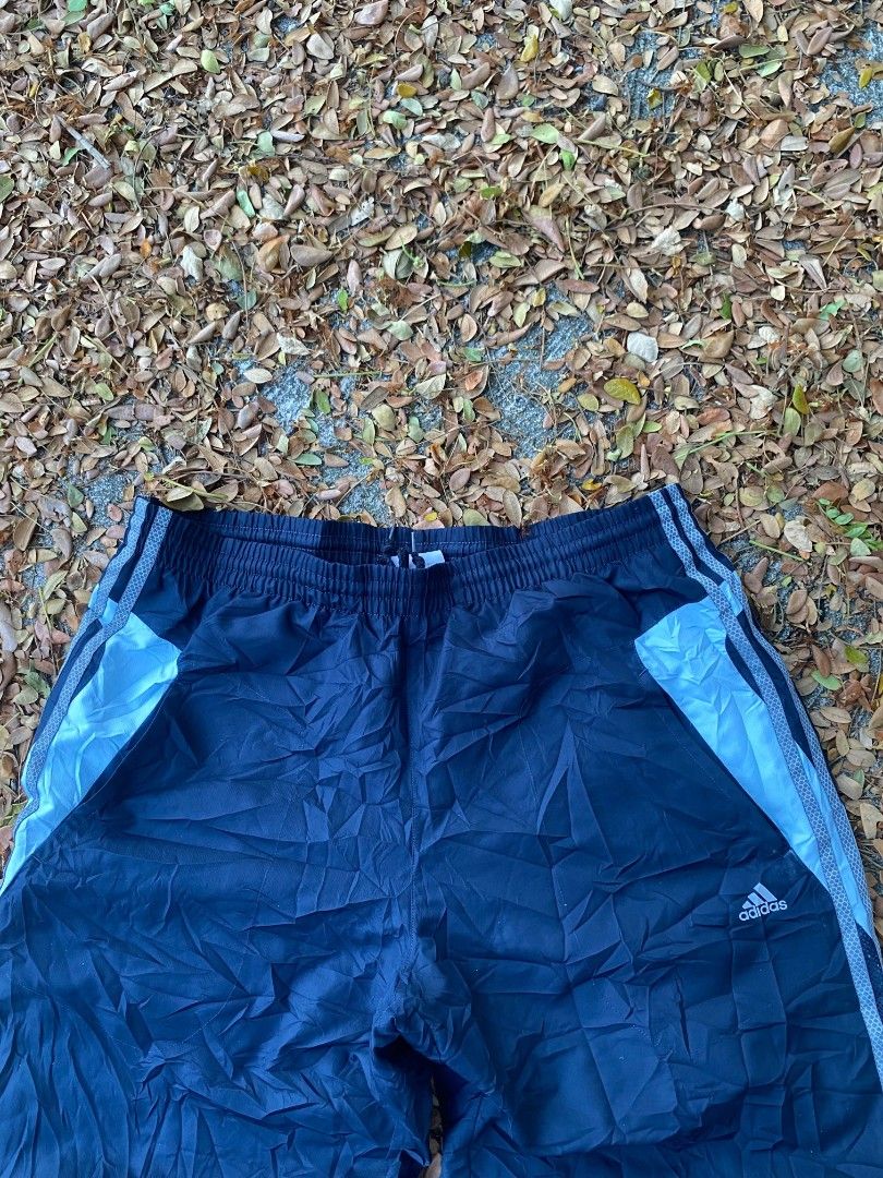 Adidas Navy Blue Track Pants Size XL (Category: Joggers) located in Manila. Submitted by bognalosjo69319 (Listing ID 1465134049, Image 2). Description: - Brand: Adidas - Color: Navy blue with light blue side panels - Size: Men's XL - Fit: Classic retro athletic fit - Features: Elastic waistband, mesh inner lining, and small printed logo near the left pocket.