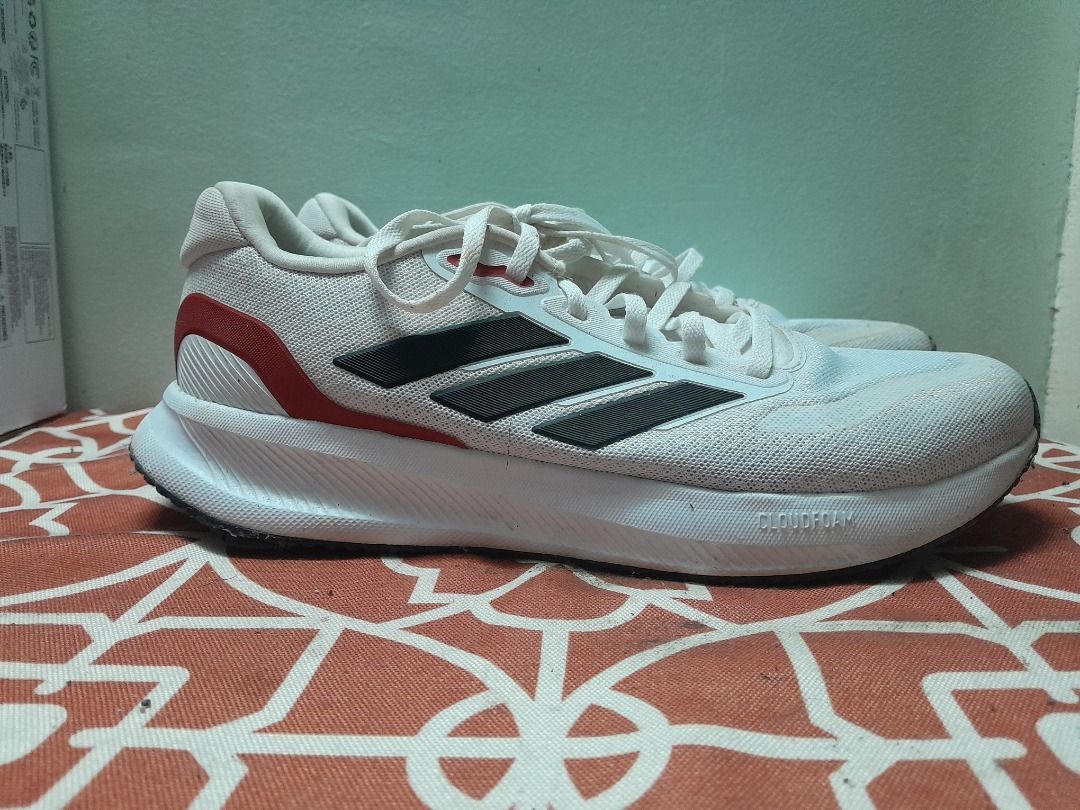 Adidas running shoes white black red (Category: Casual Shoes) located in Bontoc. Submitted by younghustler101 (Listing ID 1465073755, Image 1). Description: - Brand: Adidas - Color: White with black stripes and red heel detail - Material: Breathable mesh upper with cushioned white midsole - Closure: Lace-up - Condition: Worn a few times with minor scuffs on soles and upper mesh, plenty of life left - Best for: Daily runs or casual streetwear.
