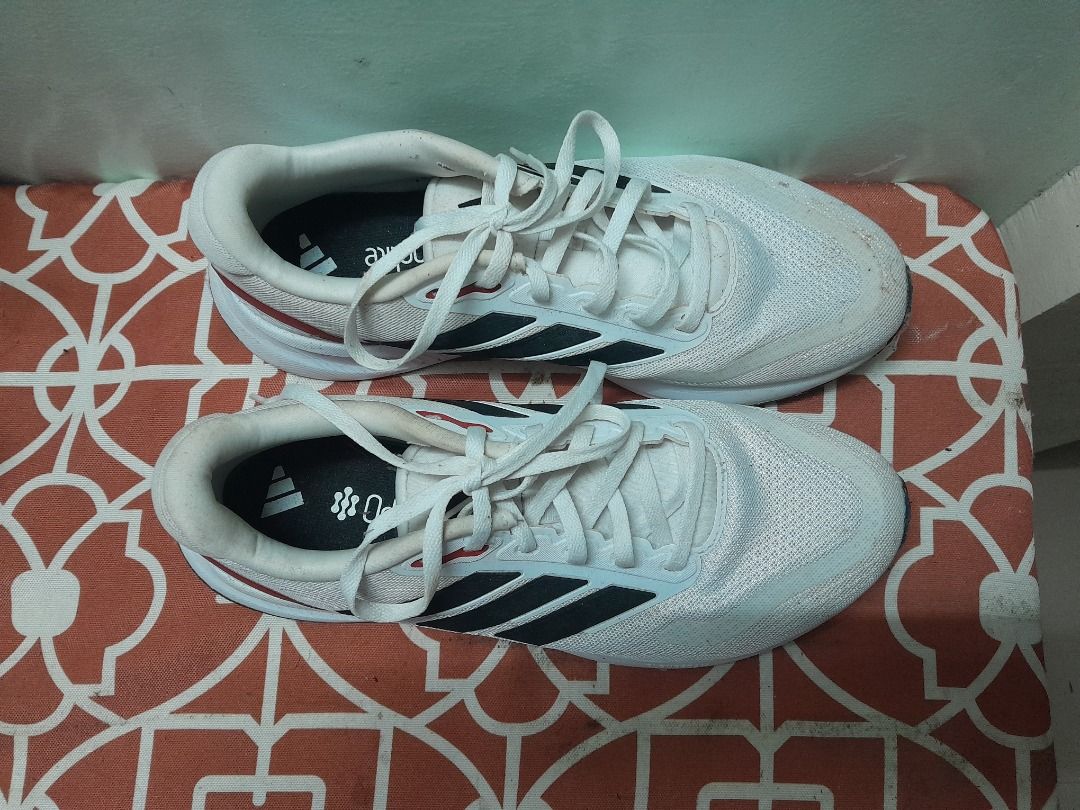Adidas running shoes white black red (Category: Casual Shoes) located in Bontoc. Submitted by younghustler101 (Listing ID 1465073755, Image 2). Description: - Brand: Adidas - Color: White with black stripes and red heel detail - Material: Breathable mesh upper with cushioned white midsole - Closure: Lace-up - Condition: Worn a few times with minor scuffs on soles and upper mesh, plenty of life left - Best for: Daily runs or casual streetwear.