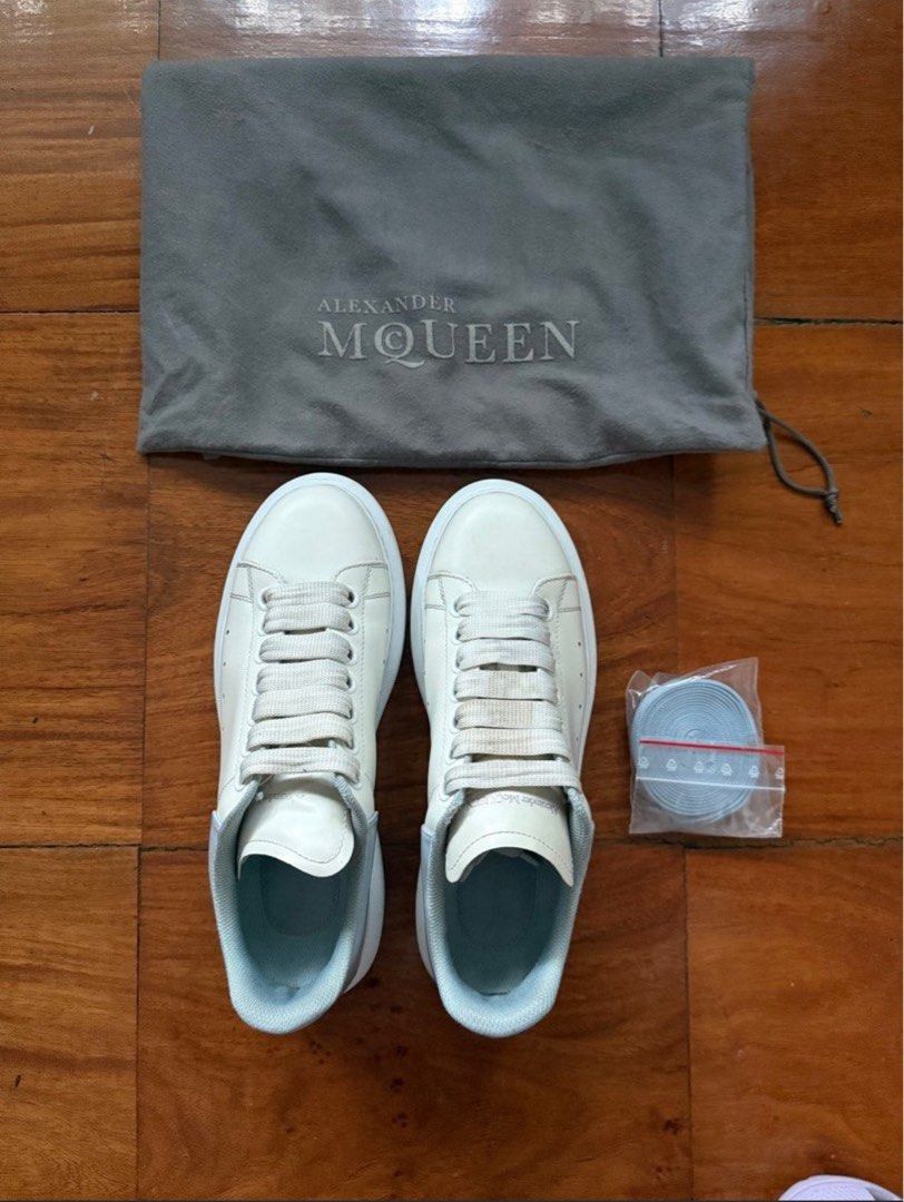 Alexander McQueen Oversized Sneakers (100% authentic)) (Category: Sneakers) located in Makati City. Submitted by thevault88 (Listing ID 1465121417, Image 2). Description: - Brand: Alexander McQueen - Color: White leather with pale blue heel counters - Sole: Chunky white rubber platform - Condition: Clean uppers with slight, normal creasing near the toe box - Inclusions: Original grey dust bag and brand new extra light blue laces in a sealed plast