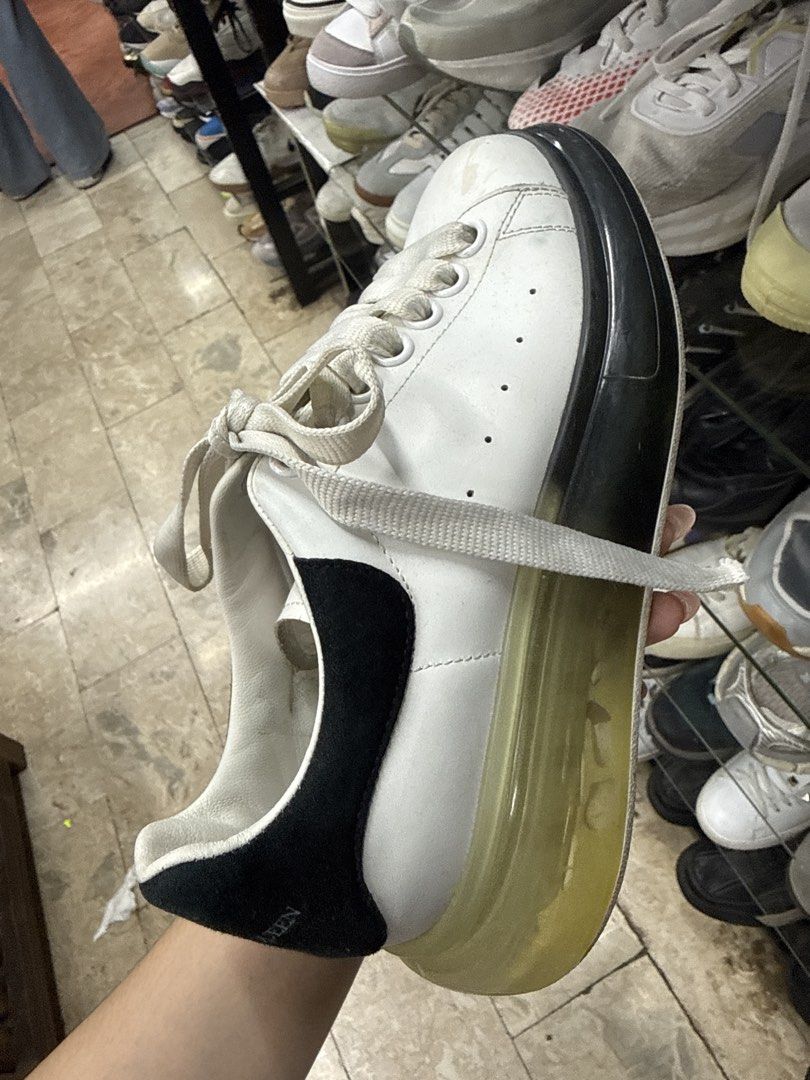 Alexander McQueen White and Black Oversized Sneakers (Category: Sneakers) located in Manila. Submitted by fastlion.584bdf (Listing ID 1465070610, Image 1). Description: - Brand: Alexander McQueen - Style: Chunky sneakers in white leather - Details: Black suede heel tab with silver branding, wide cream laces, and unique tread pattern - Sole: Thick translucent yellowed gel sole with a black front bumper detail - Condition: Pre-owned with visible we