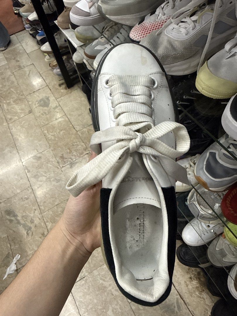Alexander McQueen White and Black Oversized Sneakers (Category: Sneakers) located in Manila. Submitted by fastlion.584bdf (Listing ID 1465070610, Image 2). Description: - Brand: Alexander McQueen - Style: Chunky sneakers in white leather - Details: Black suede heel tab with silver branding, wide cream laces, and unique tread pattern - Sole: Thick translucent yellowed gel sole with a black front bumper detail - Condition: Pre-owned with visible we