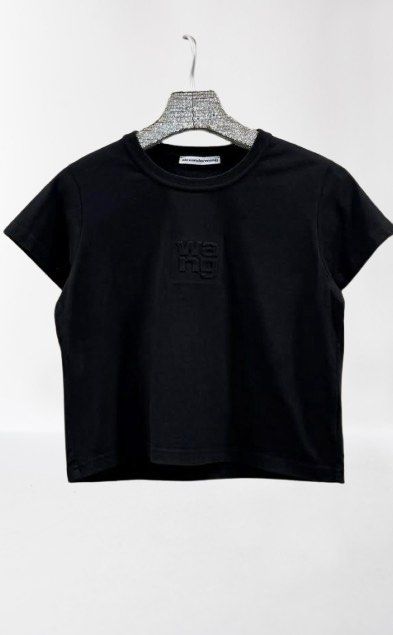 Alexander Wang Black Crop Top with Embossed Logo (Category: Shirts) located in Manila. Submitted by decluterthings888 (Listing ID 1465109188, Image 1). Description: - Brand: Alexander Wang - Color: Black - Style: Short-sleeve crop top with crew neck - Detail: Embossed 'wang' lettering on the front chest - Material: Soft, high-quality cotton with clean stitching - Fit: True to size, great for pairing with high-waisted jeans or shorts.