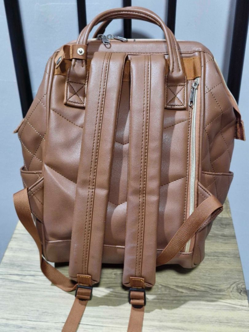 Anello Quilted Brown Leather Backpack with Top Handles (Category: Backpacks) located in Davao. Submitted by j_guitarist (Listing ID 1465065432, Image 2). Description: - Brand: Anello - Material: Premium faux leather with clean brown fabric lining - Color: Classic brown with elegant gold-toned hardware - Design: Quilted finish with dual top carry handles and adjustable shoulder straps - Storage: Convenient zippered front pocket and interior slip p