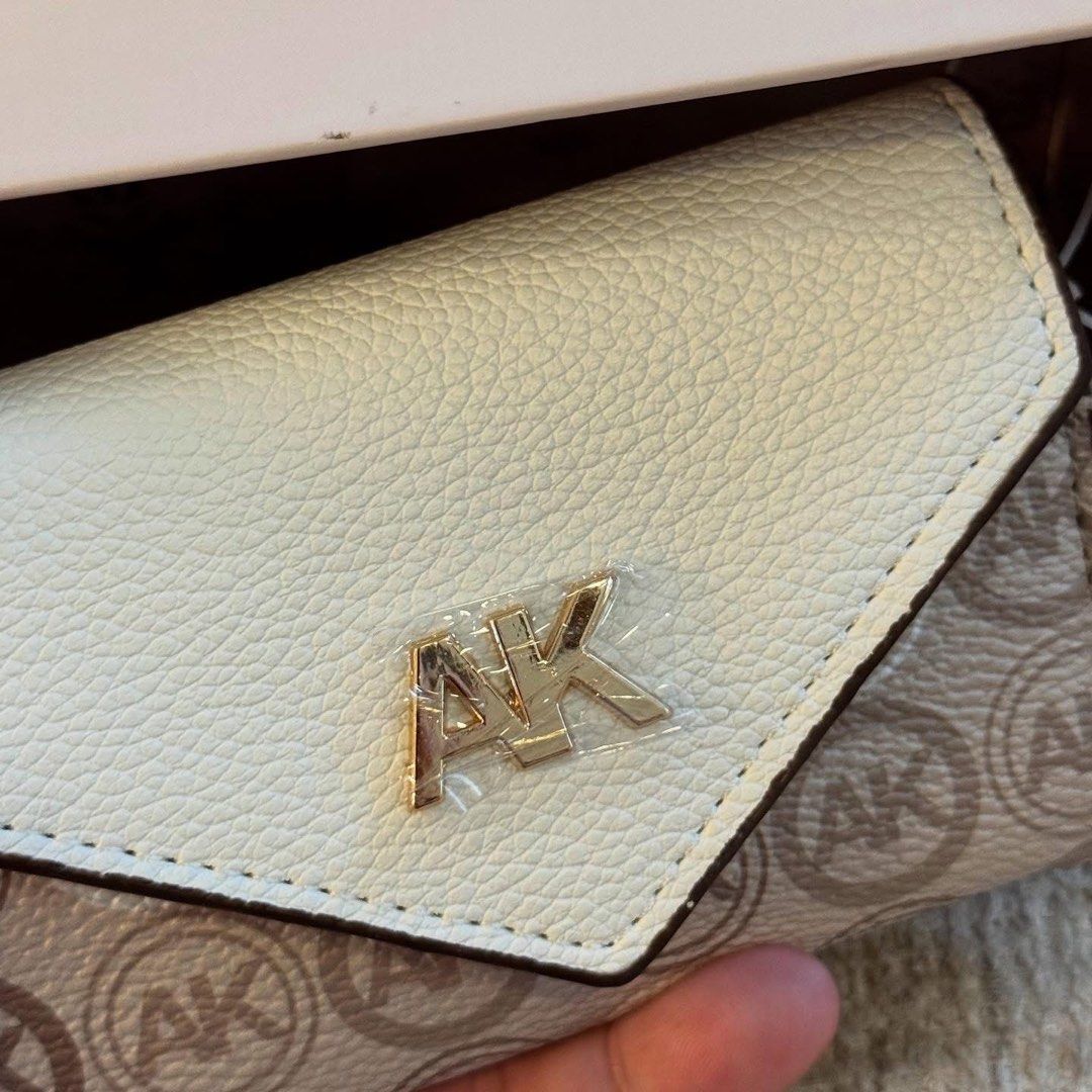 Anne Klein Monogram Card Holder with Box (Category: Wallets & Card holders) located in Manila. Submitted by luwiswisz (Listing ID 1465053751, Image 3). Description: - Brand: Anne Klein - Design: Cream and beige monogram with classic AK logo - Material: Polyurethane body with polyester lining - Closure: Snap button - Features: Interior space for cards and cash - Condition: Brand new, never used, properly stored - Inclusions: Original box and tags 