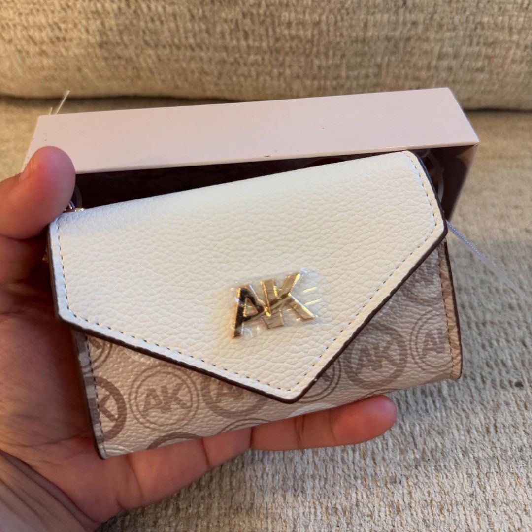 Anne Klein Monogram Card Holder with Box (Category: Wallets & Card holders) located in Manila. Submitted by luwiswisz (Listing ID 1465053751, Image 2). Description: - Brand: Anne Klein - Design: Cream and beige monogram with classic AK logo - Material: Polyurethane body with polyester lining - Closure: Snap button - Features: Interior space for cards and cash - Condition: Brand new, never used, properly stored - Inclusions: Original box and tags 